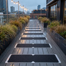 Black grit flat aluminium anti-slip plates screwed across a wet composite walkway on a rooftop bar terrace