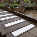 White 115 x 1000mm anti-slip plates on a dark timber access ramp in a care home garden