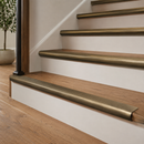 Antique brass 89mm ribbed stair nosings on oak treads with cream risers