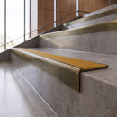 Antique Brass anti-slip stair nosing with amber CarbiGrip insert fitted to concrete steps