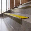 Antique Brass anti-slip stair nosing with canary yellow ridged PVC insert fitted to concrete steps