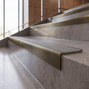 Antique Brass anti-slip stair nosing with fog grey ridged PVC insert fitted to concrete steps