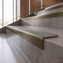 Antique Brass anti-slip stair nosing with pebble CarbiGrip insert fitted to concrete steps