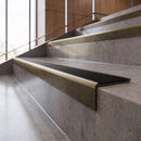 Antique Brass anti-slip stair nosing with black ridged PVC insert fitted to concrete steps