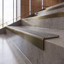 Antique Brass anti-slip stair nosing with speckled pebble CarbiGrip insert fitted to concrete steps
