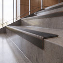 Antique Bronze anti-slip stair nosing with graphite CarbiGrip insert fitted to concrete steps