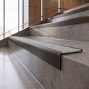 Antique Bronze anti-slip stair nosing with Italian marble CarbiGrip insert fitted to concrete steps