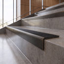 Antique Bronze anti-slip stair nosing with obsidian CarbiGrip insert fitted to concrete steps