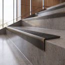 Antique Bronze anti-slip stair nosing with speckled obsidian CarbiGrip insert fitted to concrete steps