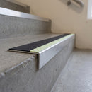 Aluminium stair nosing 56x32mm with photoluminescent strip and a black anti-slip PVC insert, fitted to a concrete step