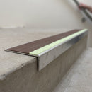 Aluminium stair nosing 56x32mm with photoluminescent strip and a brown anti-slip PVC insert, fitted to a concrete step