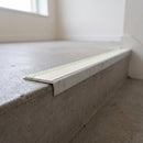 Aluminium stair nosing 56x32mm with photoluminescent strip and a canvas anti-slip PVC insert, fitted to a concrete step