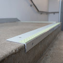 Aluminium stair nosing 56x32mm with photoluminescent strip and an ice grey anti-slip PVC insert, fitted to a concrete step