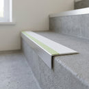 Aluminium stair nosing 56x32mm with photoluminescent strip and a white anti-slip PVC insert, fitted to a concrete step