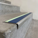 Ramped aluminium stair nosing 66x32mm with photoluminescent strip and a cobalt blue anti-slip PVC insert, fitted to a concrete step