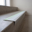 Ramped aluminium stair nosing 66x32mm with photoluminescent strip and an ice grey anti-slip PVC insert, fitted to a concrete step