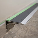 Ramped aluminium stair nosing 66x32mm with photoluminescent strip and a midnight grey anti-slip PVC insert, fitted to a concrete step