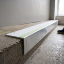 Aluminium stair nosing 56x55mm deep riser with photoluminescent strip and a white anti-slip PVC insert, fitted to a concrete step