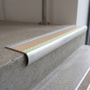 Bullnose aluminium stair nosing 69x40mm with photoluminescent strip and a beige anti-slip PVC insert, fitted to a concrete step