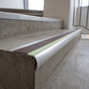Bullnose aluminium stair nosing 69x40mm with photoluminescent strip and a brown anti-slip PVC insert, fitted to a concrete step