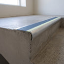 Bullnose aluminium stair nosing 69x40mm with photoluminescent strip and a cobalt blue anti-slip PVC insert, fitted to a concrete step