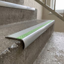 Bullnose aluminium stair nosing 69x40mm with photoluminescent strip and an ice grey anti-slip PVC insert, fitted to a concrete step