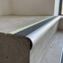 Bullnose aluminium stair nosing 69x40mm with photoluminescent strip and a midnight grey anti-slip PVC insert, fitted to a concrete step