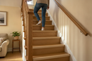 uPVC wood effect stair nosing in Oak — real-life installation on UK staircase with person using the stairs