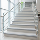 Grey flexible PVC stair nosing on concrete steps in modern UK public building