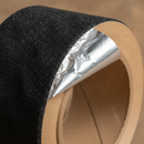 Close-up of conformable anti-slip tape showing aluminium foil backing and silicon carbide grit surface