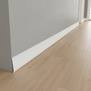 White flexible self-adhesive skirting board trim installed in modern UK hallway
