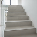 Tile-in aluminium step edging installed on ceramic tiled staircase in modern UK home - flush step nose profile