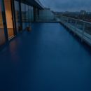 Dark Blue TerraceShield anti-slip balcony paint applied to a balcony floor, a rooftop terrace of a commercial building