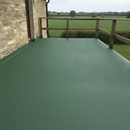 Dark Green TerraceShield anti-slip balcony paint applied to a balcony floor, a countryside cottage balcony overlooking green fields