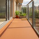 Terracotta TerraceShield anti-slip balcony paint applied to a balcony floor, a sunny apartment balcony with a small herb garden