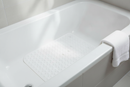 White non-slip suction bath mat laid inside a modern tiled bathtub