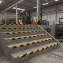 Black and yellow hazard stripe GRP stair nosing inside UK factory manufacturing plant
