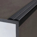 Close-up of black anodised 36x20mm aluminium stair nosing with two ribbed anti-slip rubber inserts on a step edge
