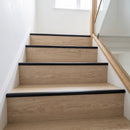 Black anodised LVT stair nosing 42x28mm fitted on light oak vinyl stairs with glass balustrade