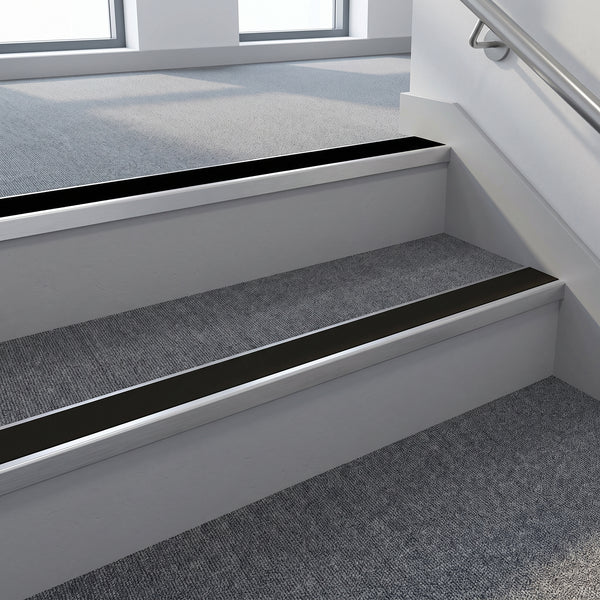 Black PVC insert fitted in aluminium stair nosings on an office stairwell