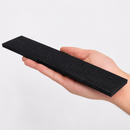 Hand holding a short length of black dovetail non-slip insert