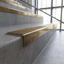 Solid brass stair nosing, 59.5mm tread with a 30mm square front, in Antique Brass finish with Antique Brass insert, fitted to a staircase