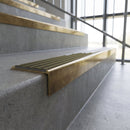 Solid brass stair nosing, 59.5mm tread with a 30mm square front, in Antique Brass finish with Antique Bronze insert, fitted to a staircase