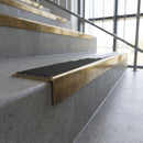 Solid brass stair nosing, 59.5mm tread with a 30mm square front, in Antique Brass finish with Black Smooth Textured insert, fitted to a staircase