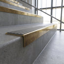 Solid brass stair nosing, 59.5mm tread with a 30mm square front, in Antique Brass finish with Flint Castellated insert, fitted to a staircase