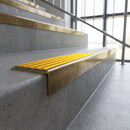 Solid brass stair nosing, 59.5mm tread with a 30mm square front, in Antique Brass finish with Gold Castellated insert, fitted to a staircase