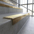Solid brass stair nosing, 59.5mm tread with a 30mm square front, in Antique Brass finish with Ivory Castellated insert, fitted to a staircase