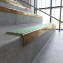 Solid brass stair nosing, 59.5mm tread with a 30mm square front, in Antique Brass finish with Jade Castellated insert, fitted to a staircase