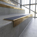 Solid brass stair nosing, 59.5mm tread with a 30mm square front, in Antique Brass finish with Regency Castellated insert, fitted to a staircase