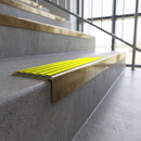 Solid brass stair nosing, 59.5mm tread with a 30mm square front, in Antique Brass finish with Yellow Castellated insert, fitted to a staircase